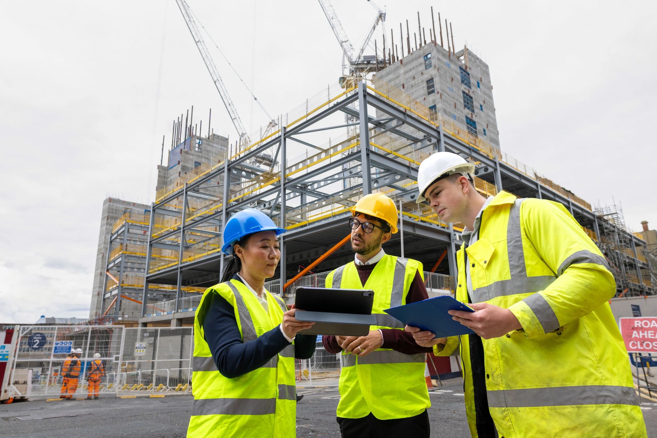 Engineering team discussing a construction project outdoors